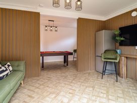 A game room with a sofa and pool table at Sea View, East Parade Llandudno