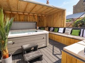 An outdoor area with a hot tub and seating at Sea View, East Parade, Llandudno