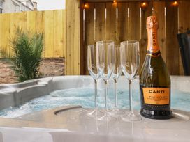 A hot tub with champagne glasses and a bottle at Sea View, East Parade Llandudno