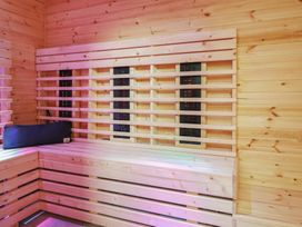 A sauna with wooden walls and heating panel at Sea View, East Parade in Llandudno