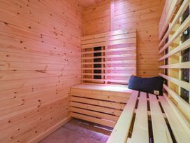 A sauna with wooden walls and benches at Sea View, East Parade Llandudno