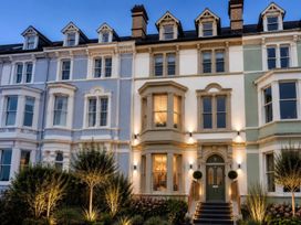 A house facade with windows, door, and plants at Sea View, East Parade, Llandudno