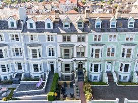 A row of terraced houses with patios at Sea View, East Parade, Llandudno