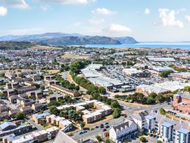 An aerial view of a town with houses, shops, and fields at Sea View, East Parade, Llandudno