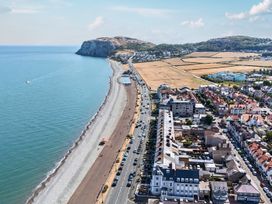 A coastline with beach and buildings at Sea View, East Parade Llandudno