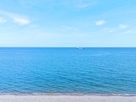 A view of the sea with a ship and a buoy at Sea View, East Parade Llandudno
