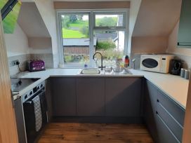 A kitchen with a sink and stove at 3 Bed Barn - Sleeps 6 - Parking - Wifi, Hawkshead