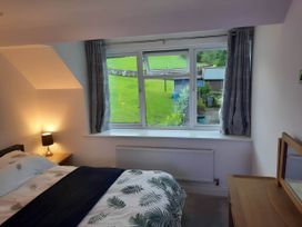 A bedroom with a bed and window at 3 Bed Barn - Sleeps 6 - Parking - WIfi Hawkshead