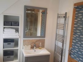 A bathroom with a sink and storage at 3 Bed Barn - Sleeps 6 - Parking - Wifi Hawkshead