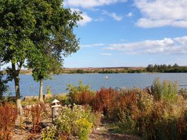 A lake with surrounding foliage at Restored circus wagon, Saltburn-By-The-Sea