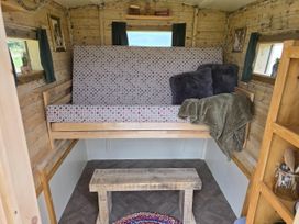 A seating area with a bench and cushions in a restored circus wagon Saltburn-By-The-Sea