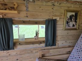 A living room with a window and curtains at Restored circus wagon in Saltburn-By-The-Sea