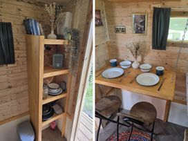 A kitchen with a table set for dining at Restored circus wagon in Saltburn-By-The-Sea