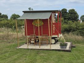A circus wagon with seating and a planter at Restored circus wagon in Saltburn-By-The-Sea