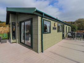 An outdoor area with seating and a modern cabin at 56 The Stables near Pwllheli