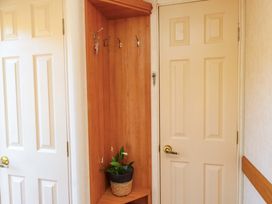 An entrance area with coat hooks and plant pot at Caravan at Argraig Llanrhyddlad near Cemaes Bay