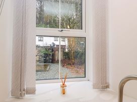 A bathroom with a window view at Bobtail Cottage in Kendal