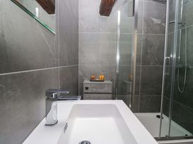 A bathroom with a sink and shower at Bobtail Cottage in Kendal