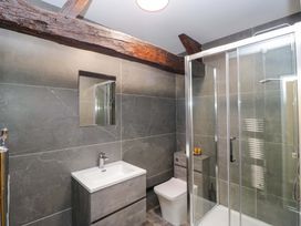 A bathroom with shower and wash basin at Bobtail Cottage in Kendal