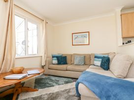 A living room with a sofa and coffee table at Oak Cottage in Falmouth