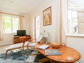 A snug room with a television and seating area at Oak Cottage in Falmouth