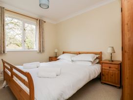 A bedroom with a bed and bedside tables at Oak Cottage in Falmouth