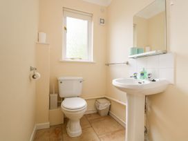 A bathroom with a toilet and sink at Oak Cottage in Falmouth