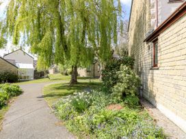 An outdoor area with a tree and flowers at Oak Cottage in Falmouth