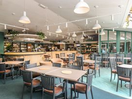 A dining room with tables and chairs at Oak Cottage in Falmouth