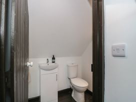 A bathroom with a toilet and a sink at Ruby’s Den Ashton Keynes
