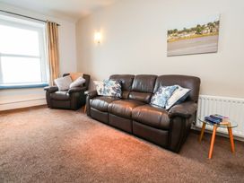 A living room with a sofa and armchair at Flat 2, Dorstan in Carnforth