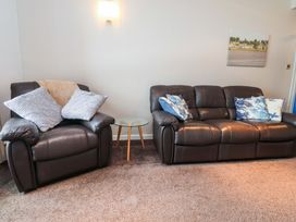 A living room with sofa and armchair at Flat 2, Dorstan in Carnforth