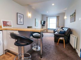 A living room with a sofa and television at Flat 2, Dorstan in Carnforth