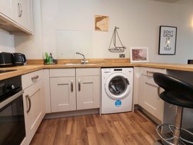 A kitchen with a washing machine and sink at Flat 2, Dorstan in Carnforth