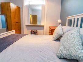 A bedroom with a bed and furniture at Flat 2, Dorstan Carnforth