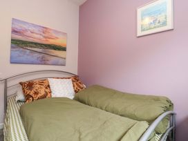 A bedroom with two single beds and wall art at Flat 2, Dorstan in Carnforth