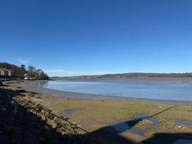 A view of a shoreline with water and trees at Flat 2, Dorstan in Arnside