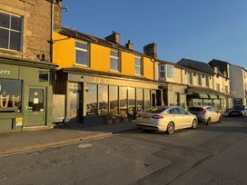 A street view with shops and cars at Flat 2, Dorstan in Arnside