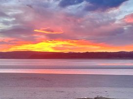 A sunset over water with clouds at Flat 2, Dorstan in Arnside