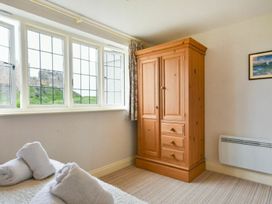 A bedroom with a wardrobe and towels at Northrawe in Bamburgh