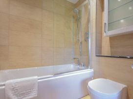 A bathroom with a shower and bathtub at Northrawe in Bamburgh
