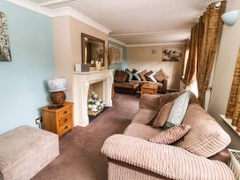 A living room with a sofa and fireplace at Blacksmiths Retreat in York
