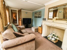 A living room with a television and fireplace at Blacksmiths Retreat in York