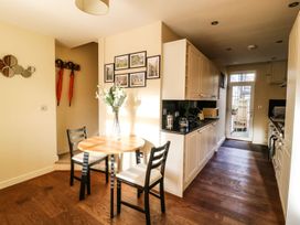 A kitchen with a dining table and chairs at Blacksmiths Retreat in York