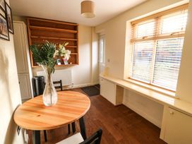 A dining room with a table and a vase in Blacksmiths Retreat York