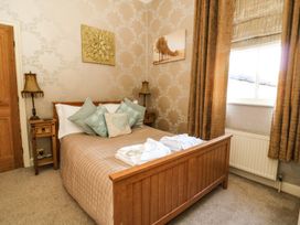 A bedroom with a bed and side tables at Blacksmiths Retreat in York