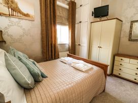 A bedroom with a bed and a wardrobe at Blacksmiths Retreat in York