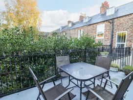 An outdoor patio with table and chairs at Blacksmiths Retreat in York