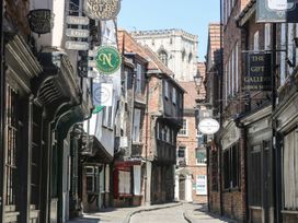A street with various shops and signs at Blacksmiths Retreat in York