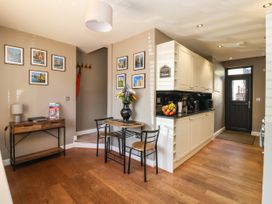 A kitchen with a table and chairs at Blacksmith Mews, York